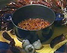 classic chili in a pot surrounded by ingredients