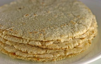 Fresh handmade corn tortillas cooking on the comal for dinner.