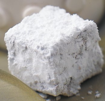 close up image of a date square covered in powdered sugar