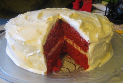 Devils Food Cake on a glass platter with slice cut out