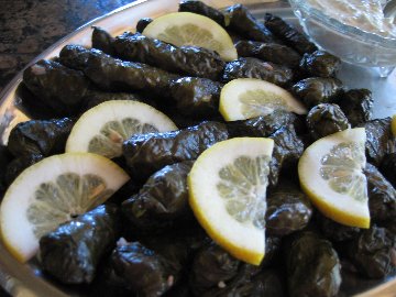 close up of Stuffed Grape Leaves garnished with fresh lemon slices