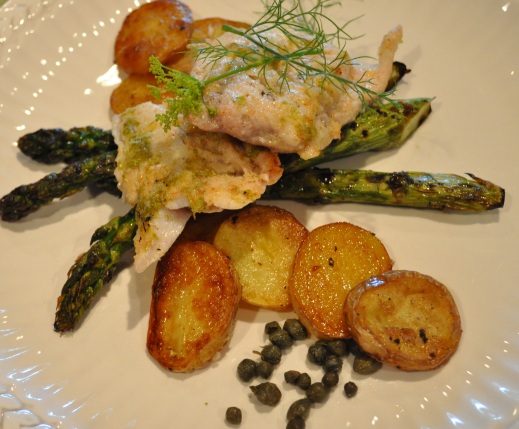 Grilled Fish with Baby Potatoes and Asparagus plated artfully on a large white dish