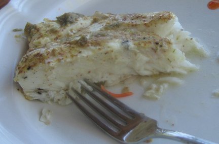 Grilled Halibut with Lime-Mustard Sauce on a white play with a fork