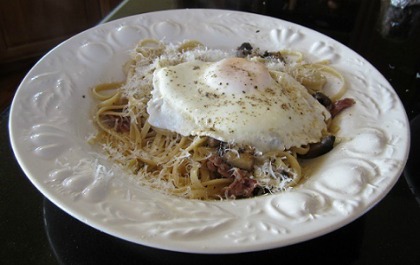 Linguine with Fried Egg served on a white dinner plate