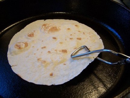 frying tortilla in cast iron skillet