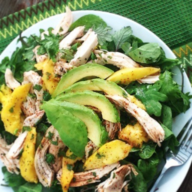 Mango Avocado Chicken Salad served on a white plate outdoors