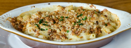 Macaroni and Cheese served in a large white ceramic serving dish