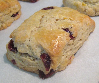close up of Orange Cranberry Scone cooling on a white dish