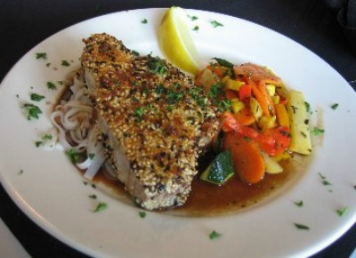 Pepper Crusted Halibut with chile-mint sauce artfully plated on a white dish