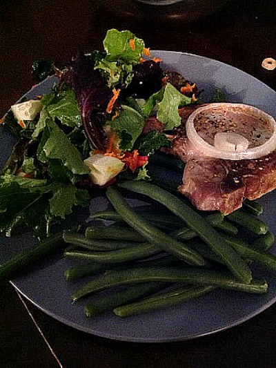 Pork Chops Supreme served on a dark plate