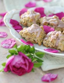 plate of rose petal drop scones covered in magenta rose petals next to a rose