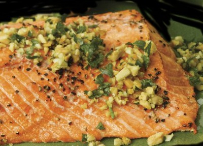 close up image of Salmon Piccata garnished with garlic 