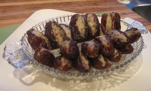 Gorgonzola Stuffed Dates arranged on a glass serving tray