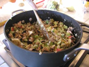 wooden spoon mixing turkey stuffing in a pot