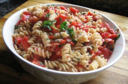 Tomato Basil Pasta Salad served in a white bowl