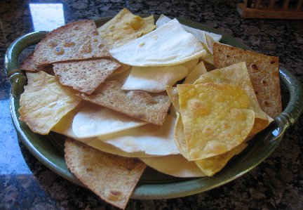 a plate with lots of homemade tortilla chips of different colors