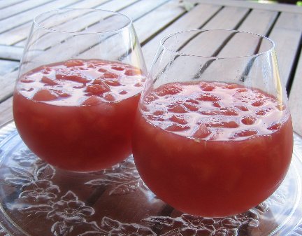 Watermelon in Rose-Lime Syrup in wine glasses on a deck