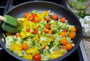 Adding tomatoes to Zucchini Frittata