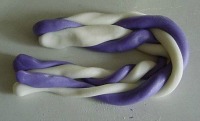 twisted fondant folded in half in a horseshoe shape on counter
