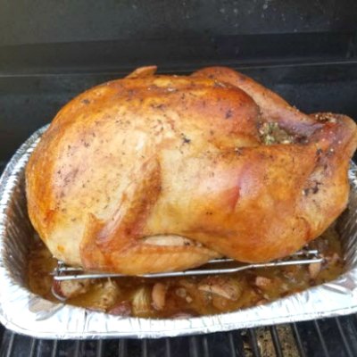Barbecued whole Turkey on a tin pan in an oven