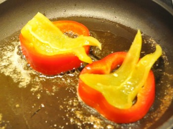 Bell peppers cooking in pan