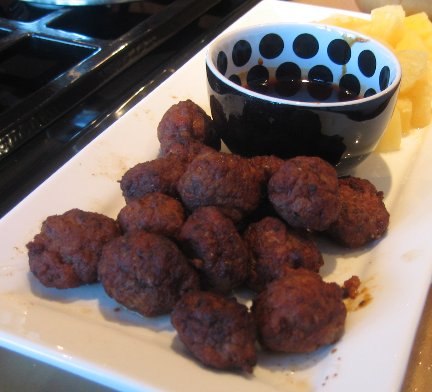 Spanish Mini Meatballs on a white plate with dipping sauce in small bowl