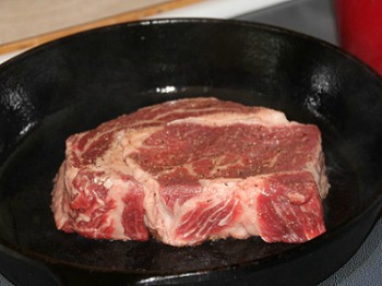 Prime Rib cooking in cast iron skillet