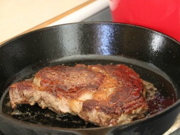 Prime Rib cooking in cast iron skillet