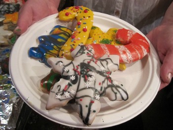 pile of merry christmas cookies of all shapes on a white plate