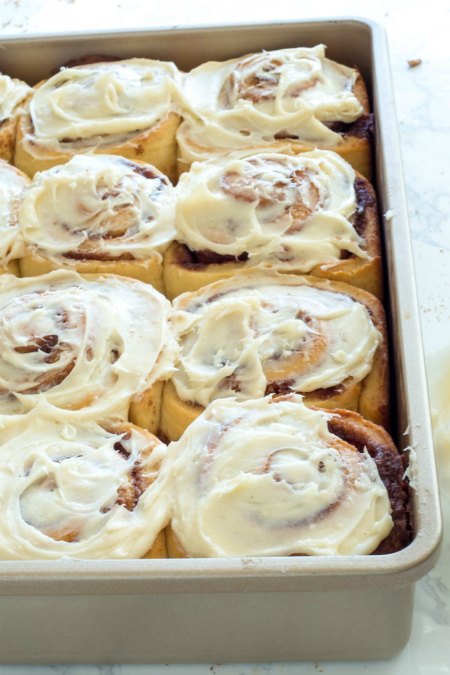 perfect cinnamon rolls-topped with frosting and ready to eat