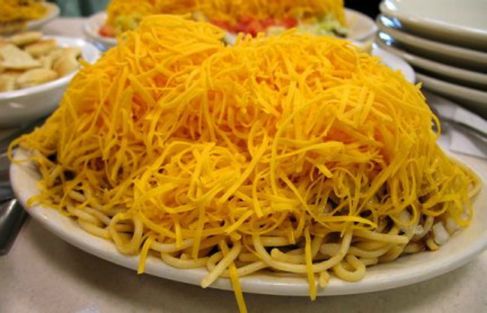 Mound of cheese covering Cincinnati Chili on a plate