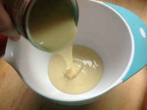 Pouring condensed milk into bowl