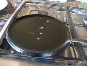 Sizzling oil on cast iron skillet