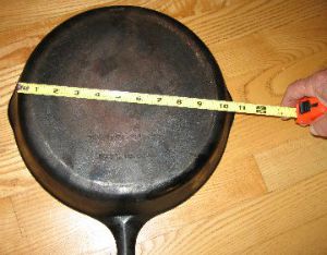 Measuring cast iron pan on bottom