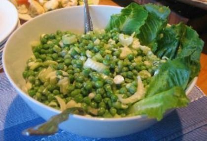 Green Pea Salad from the pea recipe collection in a large white salad bowl garnished with romaine