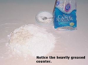 pile of cane sugar on heavily greased white counter top