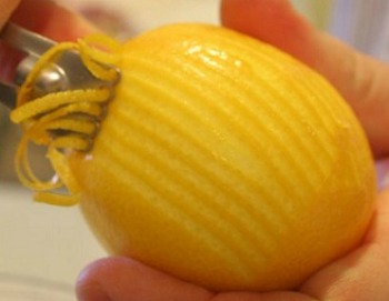 Lemon with zest being removed