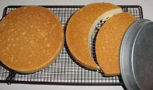 two round cakes on cooling rack, one is cut out in the shape of a moon