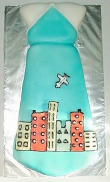 Fathers Day Cake in the shape of a tie with a colorful city skyline pattern