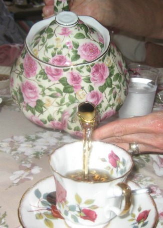 Pouring Tea into a floral tea cup at a tea party