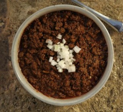 Pedernales River Chili in a bowl with a fork and 