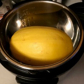 whole spaghetti squash sitting in instant pot pressure cooker