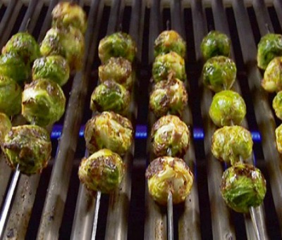 skewered brussels sprouts on a grill top