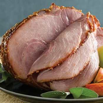 Spiral Cut Ham cross section on a plate served with vegetables
