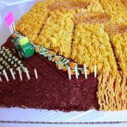 sheet cake decorated to look like a crop field with a tractor driving through it