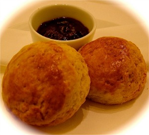 two plaza scones on a plate with a bowl
