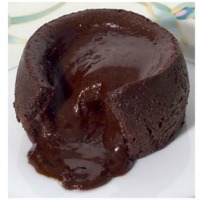 close up image of molten chocolate cake with chocolate spilling out onto a white plate