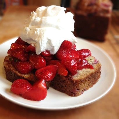 Strawberry Shortcake on Strawberry Banana Bread topped with whipped cream on a white plate